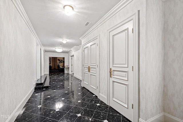 corridor with visible vents, baseboards, ornamental molding, and granite finish floor