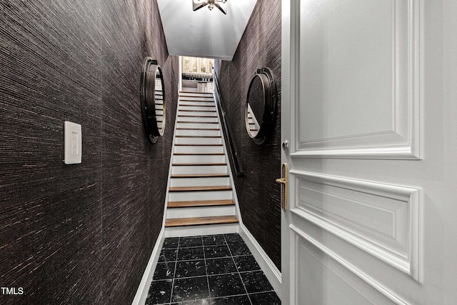 doorway with tile patterned floors, stairway, and baseboards