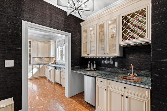 interior space with crown molding, cream cabinets, and a sink