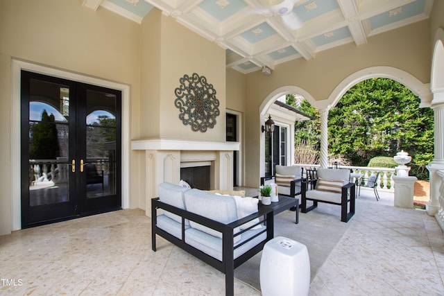 view of patio / terrace with french doors and an outdoor living space with a fireplace