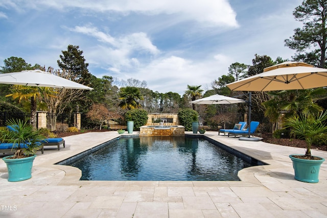 view of swimming pool with a patio area, fence, and a pool with connected hot tub