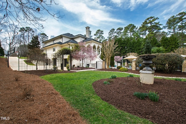 exterior space featuring a front lawn and fence