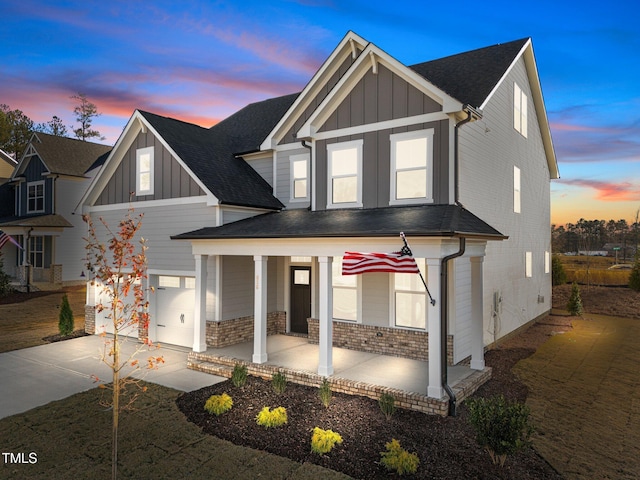 5036 Trotter Dr, Raleigh, NC 27603 - view of front of house featuring covered porch, board and batten siding, driveway, and a shingled roof