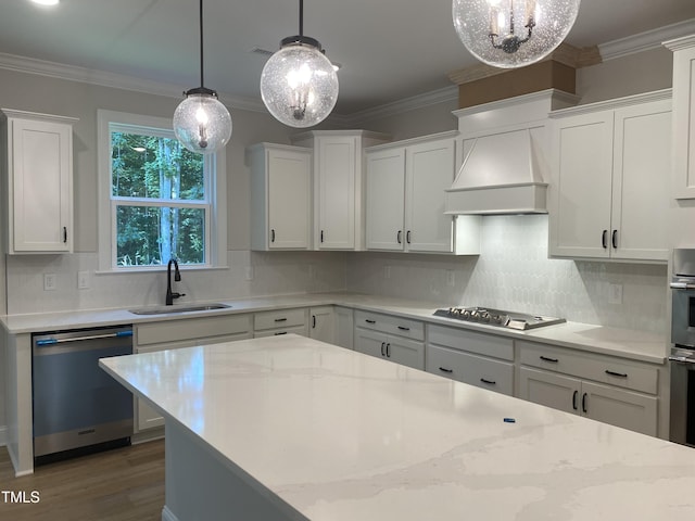 5036 Trotter Dr, Raleigh, NC 27603 - kitchen featuring appliances with stainless steel finishes, custom range hood, wood finished floors, a chandelier, and white cabinets