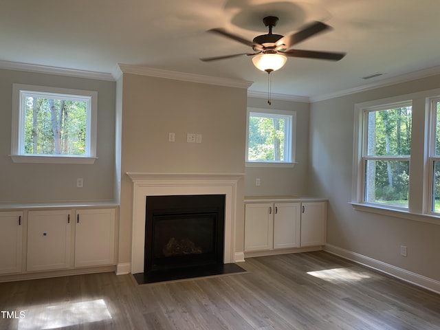 5036 Trotter Dr, Raleigh, NC 27603 - unfurnished living room featuring light wood-style flooring, crown molding, ceiling fan, and a fireplace with flush hearth