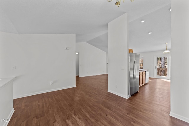 unfurnished living room featuring recessed lighting, dark wood-style flooring, vaulted ceiling, and baseboards