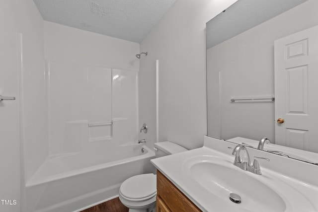 full bathroom featuring a textured ceiling, toilet, shower / bath combination, wood finished floors, and vanity