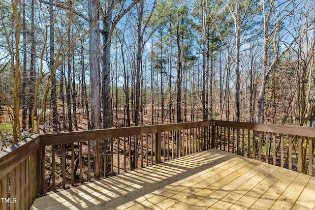 wooden deck featuring a forest view