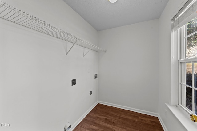 laundry area with laundry area, electric dryer hookup, baseboards, and wood finished floors