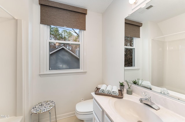 bathroom featuring a shower, visible vents, toilet, vanity, and baseboards