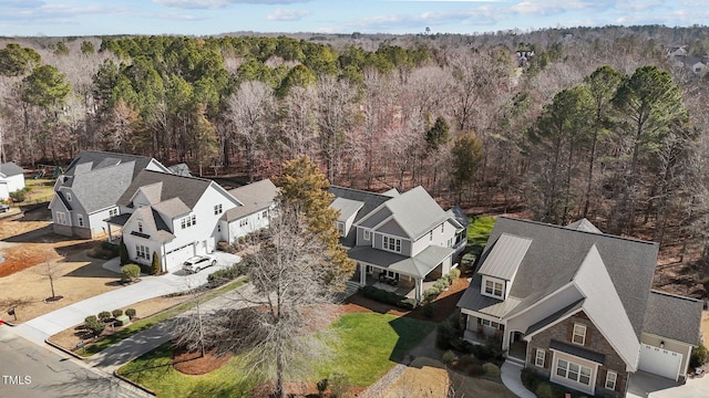 birds eye view of property featuring a residential view and a wooded view