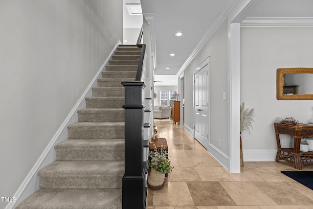 stairs with crown molding, baseboards, and recessed lighting