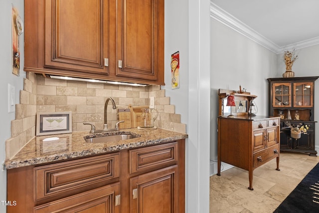 bar with ornamental molding, a sink, and decorative backsplash