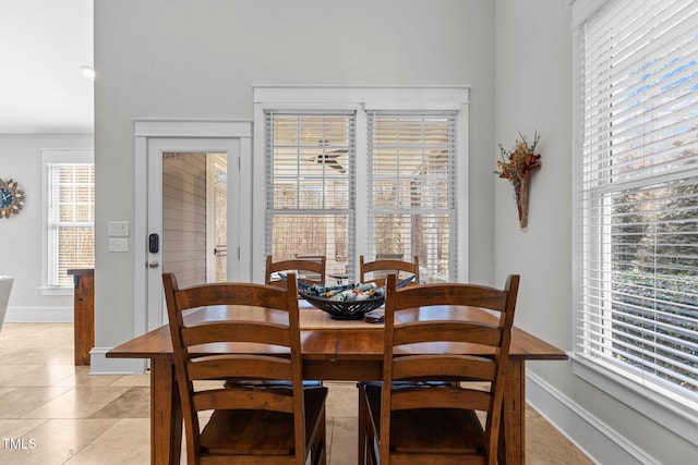 dining room with light tile patterned floors and baseboards