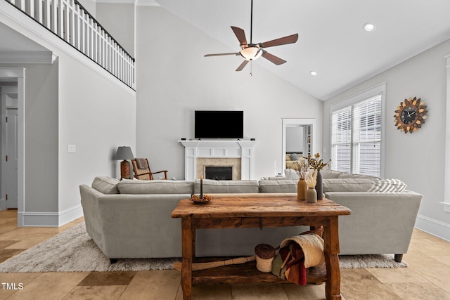 living room featuring recessed lighting, a tiled fireplace, a ceiling fan, high vaulted ceiling, and baseboards