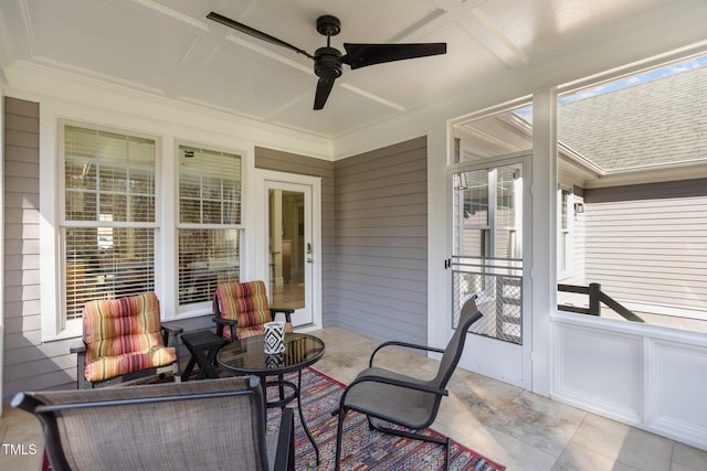 sunroom with a ceiling fan