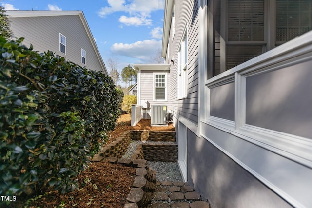 view of side of home with central AC unit