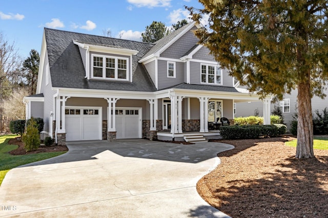 view of front of home featuring a garage, stone siding, a porch, and concrete driveway