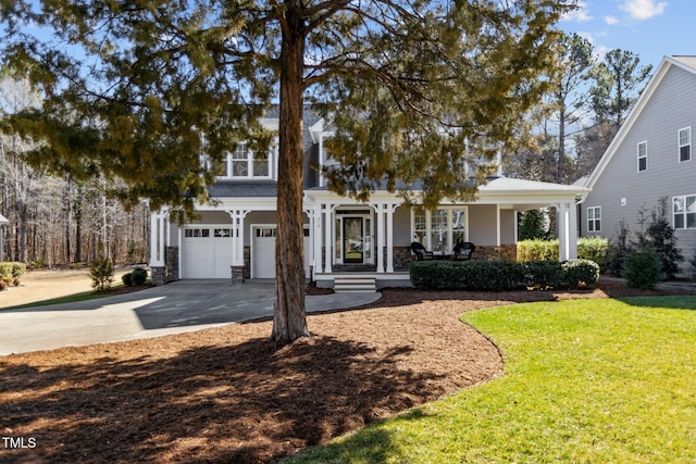 view of front of property with a garage, driveway, stone siding, and a front yard