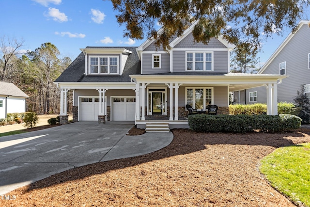 view of front facade featuring covered porch, driveway, and an attached garage