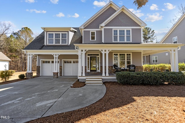 view of front of home with covered porch, an attached garage, and concrete driveway