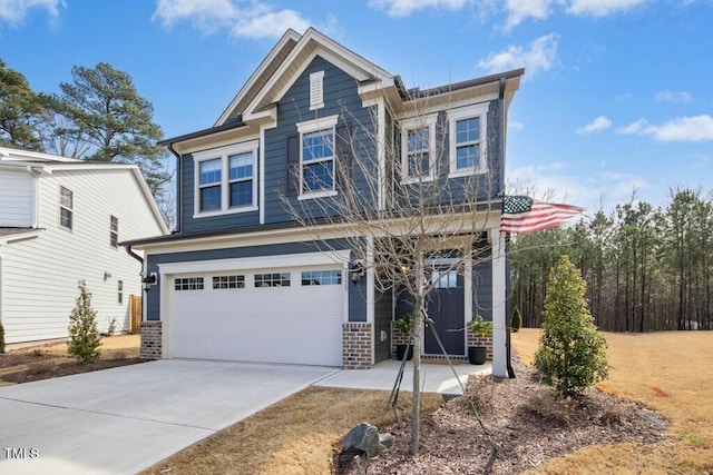 craftsman house with a garage, concrete driveway, and brick siding