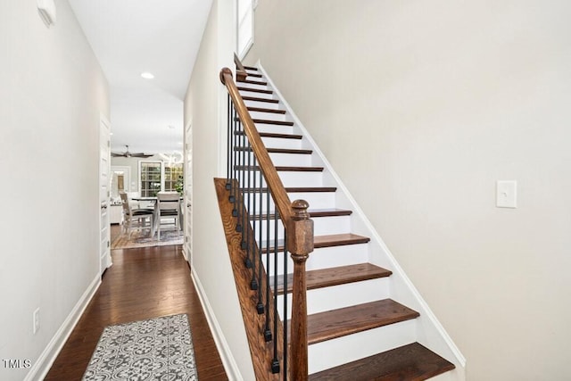 stairway featuring a ceiling fan, recessed lighting, baseboards, and wood finished floors