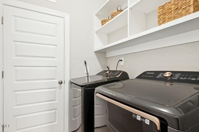 clothes washing area with laundry area and independent washer and dryer