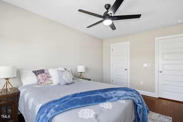 bedroom with ceiling fan, baseboards, and wood finished floors