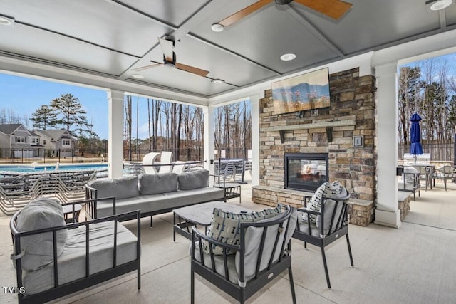 interior space featuring an outdoor stone fireplace and a ceiling fan