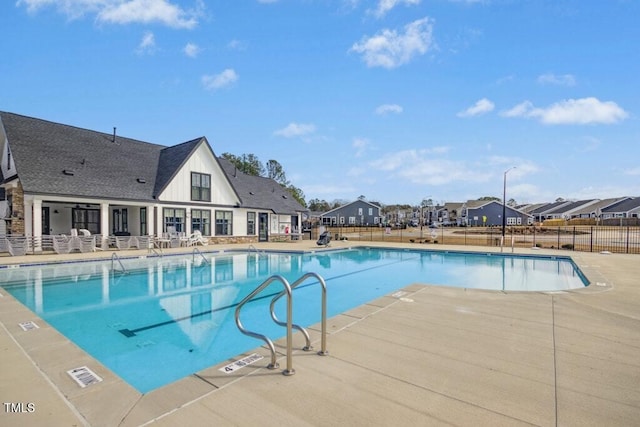 pool featuring fence and a patio