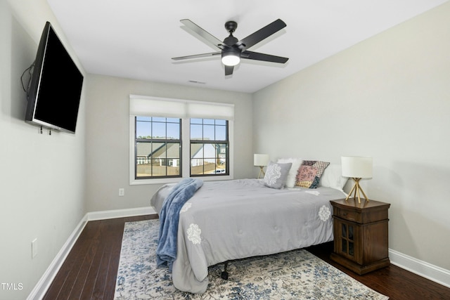 bedroom with visible vents, baseboards, and wood finished floors