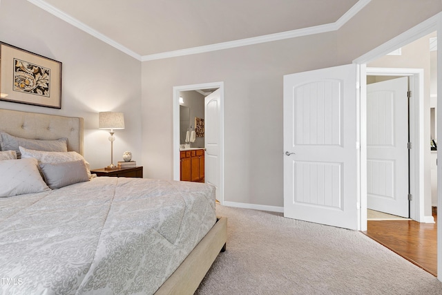 bedroom with baseboards, ensuite bathroom, light colored carpet, and crown molding