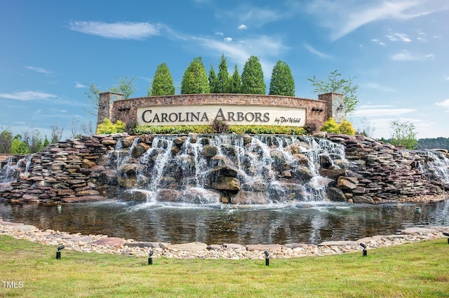 community / neighborhood sign featuring a water view