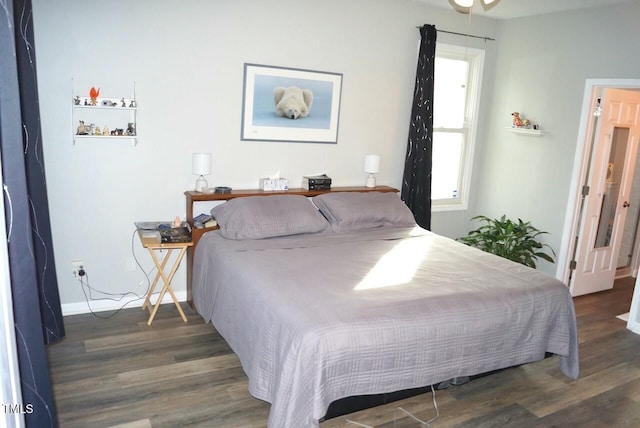 bedroom featuring dark wood-style floors and baseboards