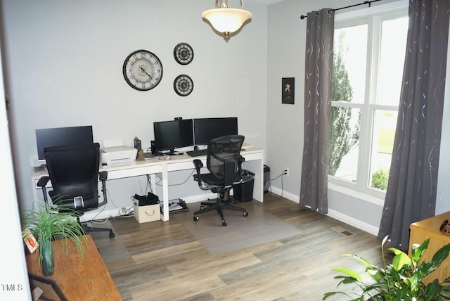 office featuring baseboards and wood finished floors