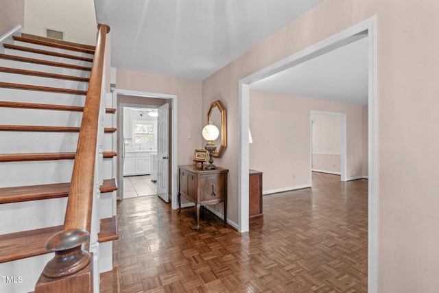 entrance foyer featuring stairway, visible vents, and baseboards