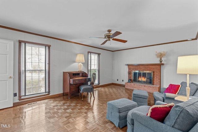 living area featuring ornamental molding, a brick fireplace, visible vents, and a healthy amount of sunlight