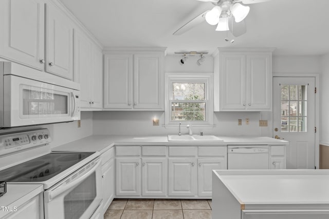 kitchen featuring light countertops, white appliances, a sink, and white cabinetry