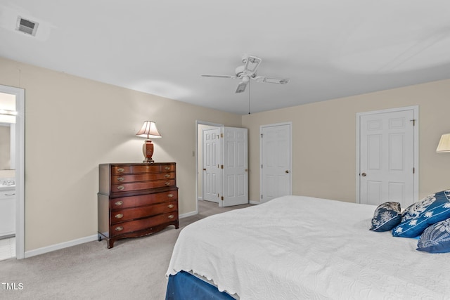 bedroom featuring light colored carpet, visible vents, a ceiling fan, connected bathroom, and baseboards