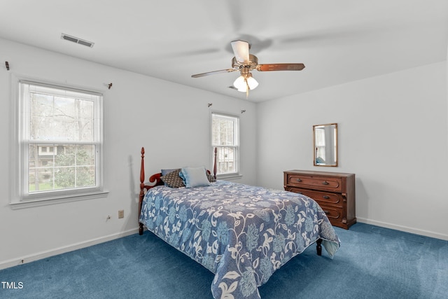 carpeted bedroom featuring a ceiling fan, visible vents, and baseboards