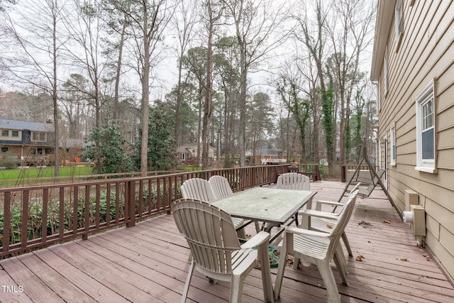 wooden terrace featuring outdoor dining area