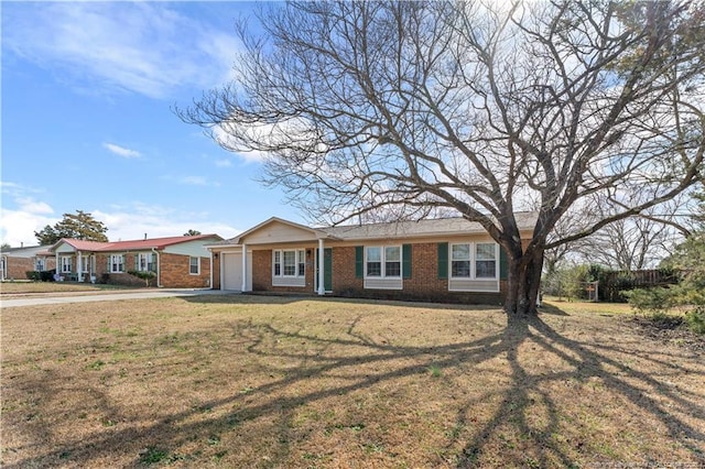 ranch-style home with a garage and a front yard