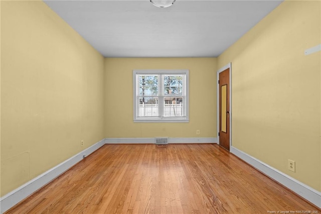 unfurnished room with light hardwood / wood-style flooring