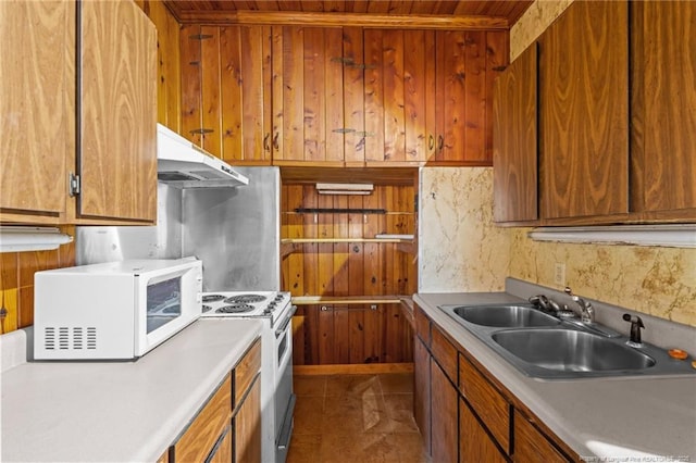 kitchen featuring white appliances and sink