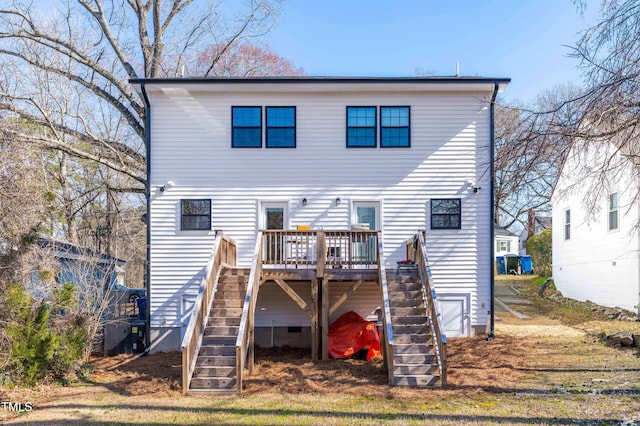 rear view of house featuring stairs and a deck