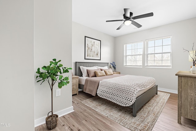 bedroom featuring baseboards, light wood-style floors, and ceiling fan