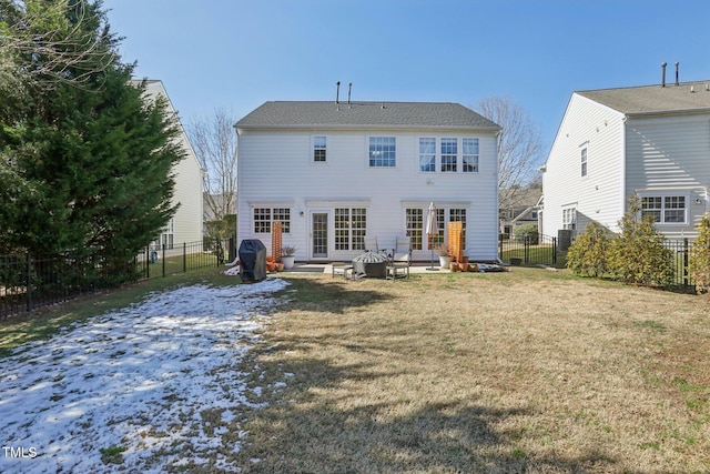 back of house with a yard, a fenced backyard, and french doors