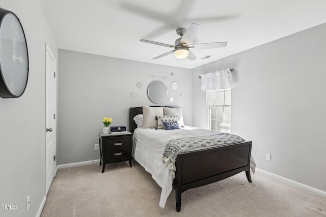 bedroom with light carpet, visible vents, baseboards, and a ceiling fan