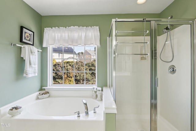 full bathroom with a stall shower and a garden tub